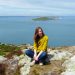 Woman sitting in front of water in Ireland