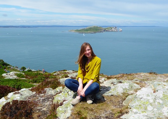 Woman sitting in front of water in Ireland